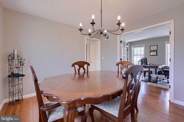 dining room with visible vents, baseboards, and wood finished floors