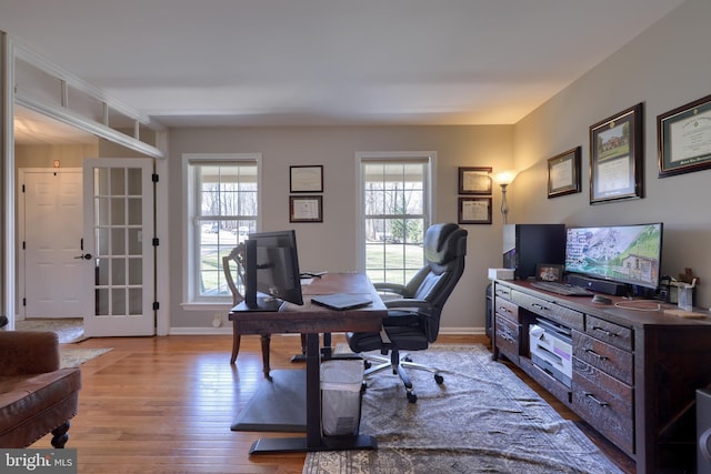 office space with wood finished floors, a healthy amount of sunlight, and baseboards