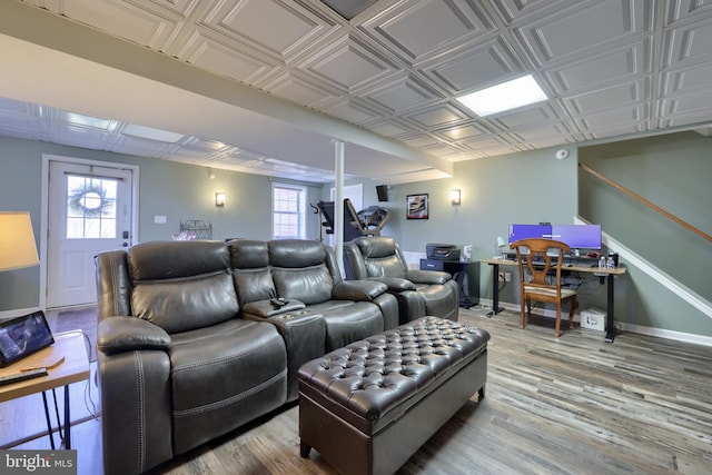 cinema with an ornate ceiling, baseboards, and wood finished floors