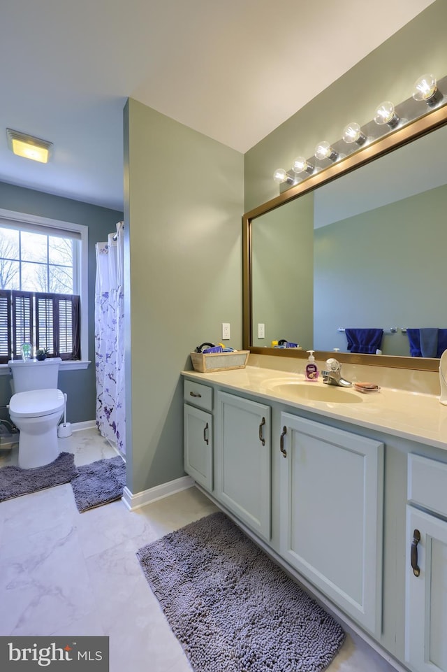 full bathroom featuring vanity, toilet, baseboards, and marble finish floor