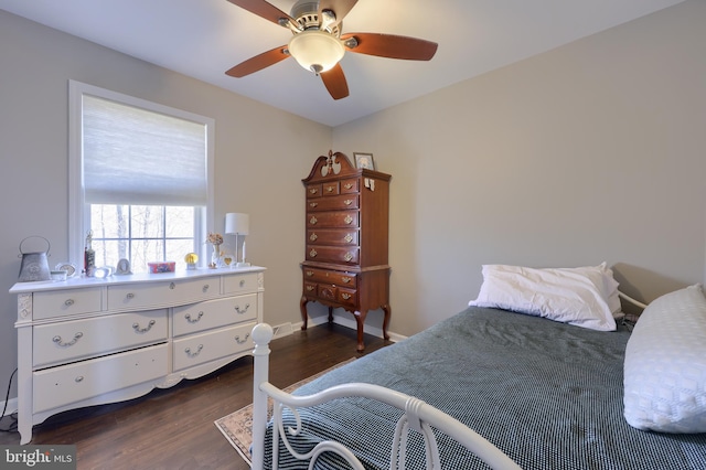 bedroom featuring a ceiling fan, baseboards, and dark wood-style flooring