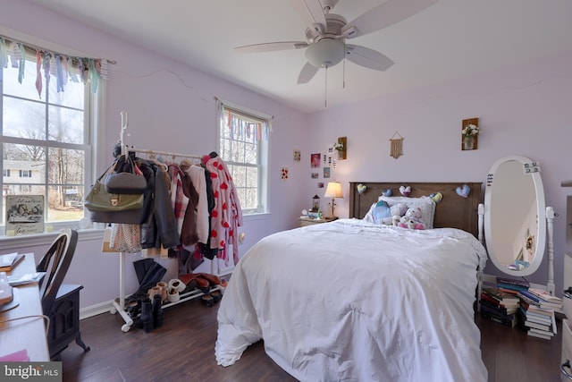 bedroom featuring dark wood-style floors, baseboards, and a ceiling fan