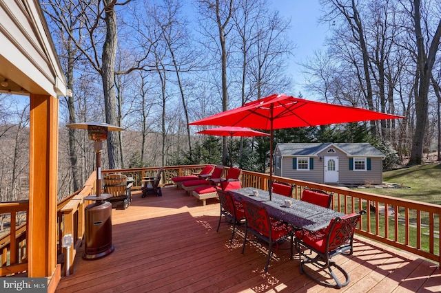 deck with an outbuilding and outdoor dining space