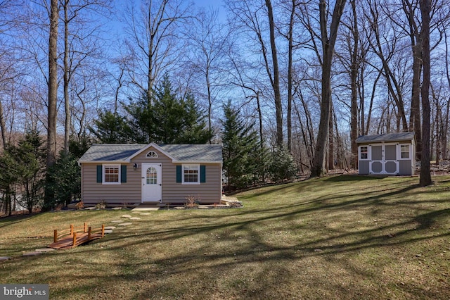 exterior space with a front lawn and an outdoor structure