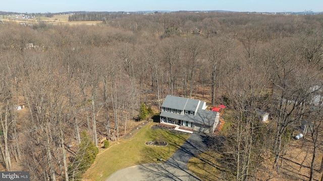 drone / aerial view featuring a forest view