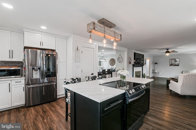 kitchen featuring stainless steel appliances, dark wood-style floors, and white cabinetry