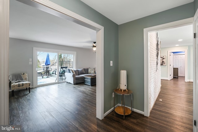 hall with baseboards and dark wood-style floors