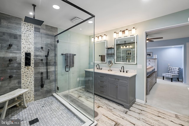 bathroom with double vanity, a stall shower, ensuite bathroom, and a sink