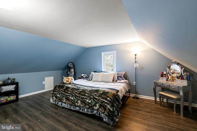 bedroom with vaulted ceiling, baseboards, and dark wood-style flooring