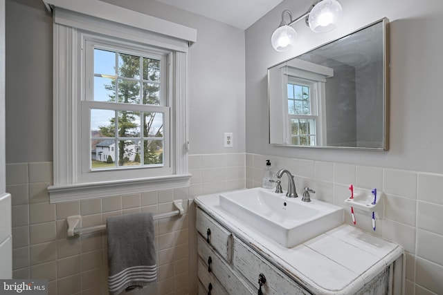 bathroom featuring vanity, tile walls, and a wainscoted wall