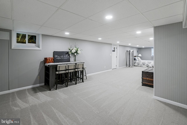 interior space featuring a drop ceiling, recessed lighting, baseboards, and carpet floors