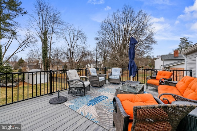 wooden deck featuring a yard, an outdoor living space, a storage unit, and an outdoor structure