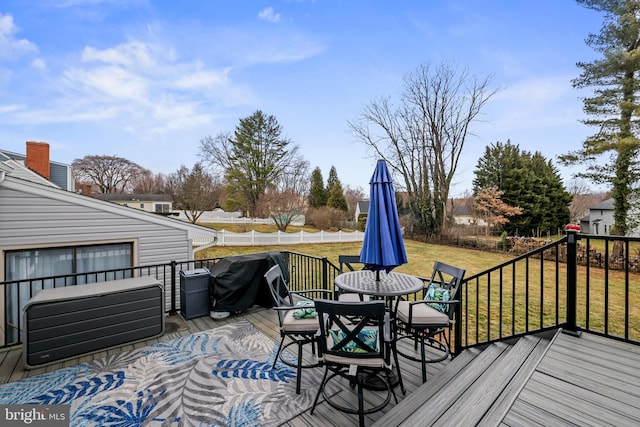 deck with grilling area, a lawn, and outdoor dining area