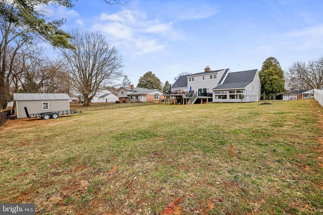 view of yard featuring a wooden deck and fence