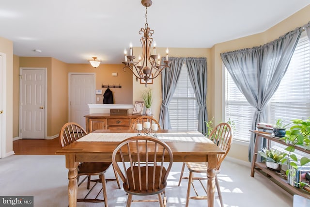 dining room with a notable chandelier and baseboards