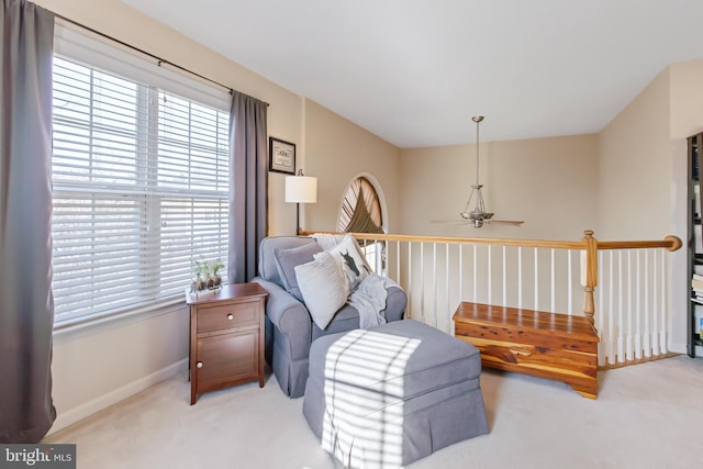 sitting room with baseboards, carpet, and a healthy amount of sunlight