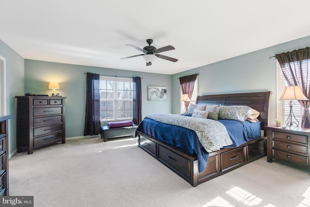 bedroom with multiple windows, a ceiling fan, and carpet floors