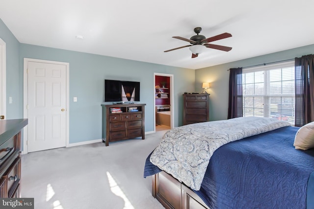 bedroom with a ceiling fan, baseboards, and light carpet