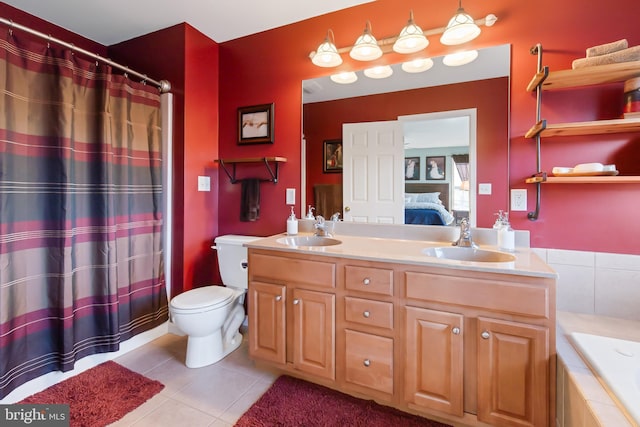 ensuite bathroom with tile patterned floors, double vanity, ensuite bath, and a sink