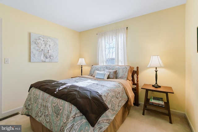 carpeted bedroom featuring visible vents and baseboards