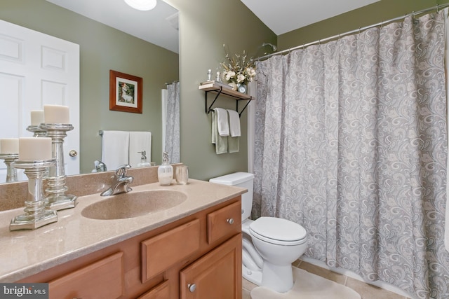 full bathroom featuring vanity, tile patterned floors, and toilet