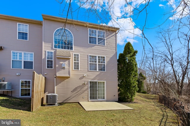 rear view of property with a patio, a yard, and cooling unit