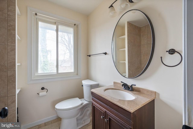 bathroom with a wealth of natural light, baseboards, toilet, and vanity