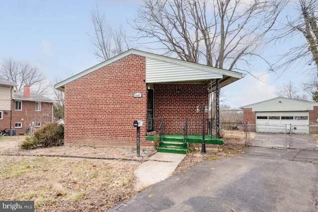 exterior space featuring an outbuilding, a gate, and fence