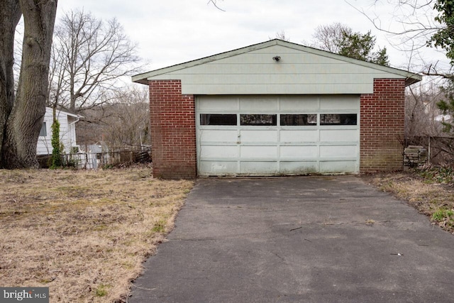 detached garage featuring fence