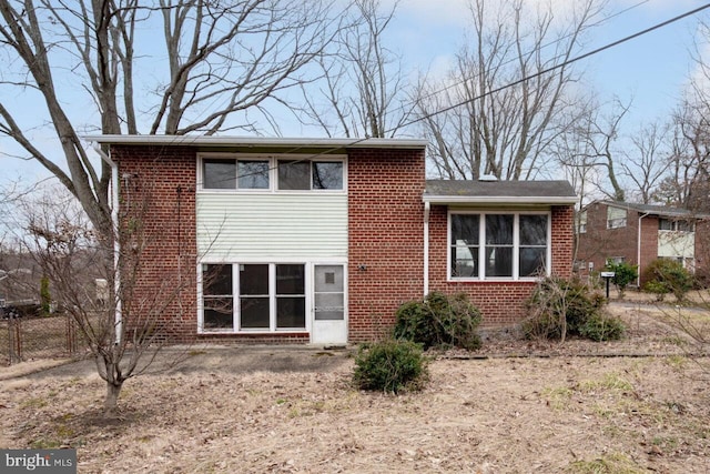 rear view of property featuring brick siding