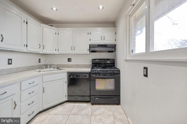 kitchen with under cabinet range hood, light countertops, white cabinets, black appliances, and a sink