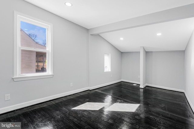 unfurnished room featuring vaulted ceiling, recessed lighting, wood finished floors, and baseboards