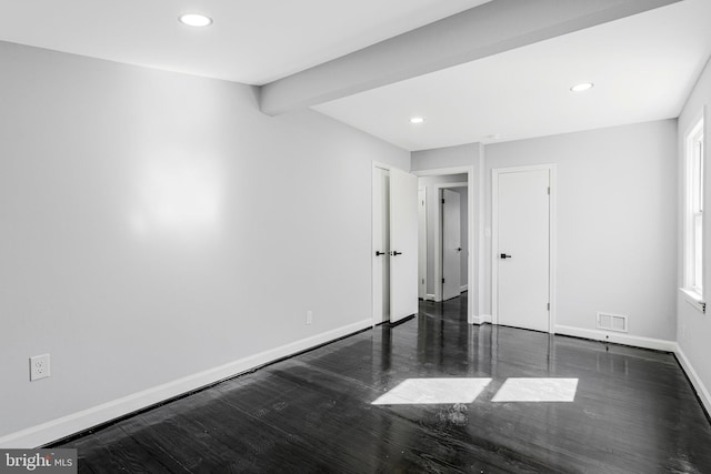 unfurnished bedroom with recessed lighting, visible vents, baseboards, and wood finished floors