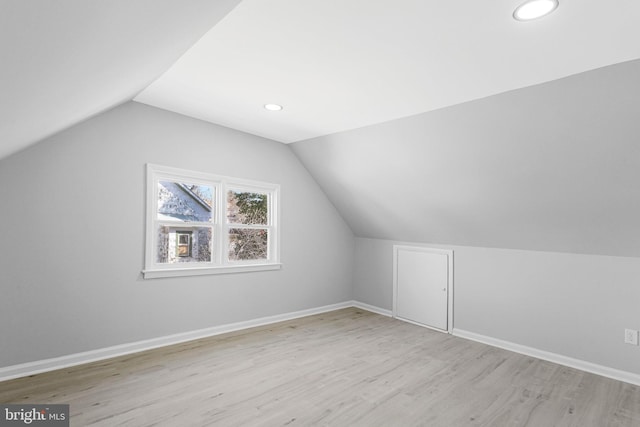 additional living space featuring recessed lighting, lofted ceiling, baseboards, and wood finished floors