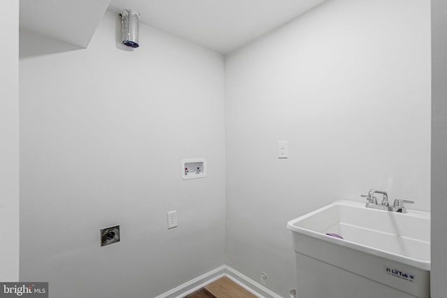 laundry area featuring a sink, baseboards, hookup for an electric dryer, hookup for a washing machine, and laundry area