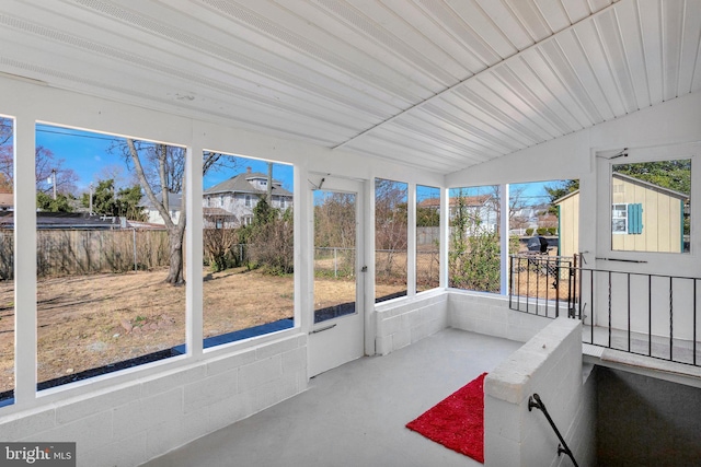 unfurnished sunroom with vaulted ceiling