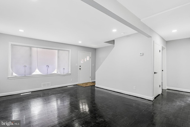 unfurnished living room with visible vents, recessed lighting, baseboards, and wood finished floors