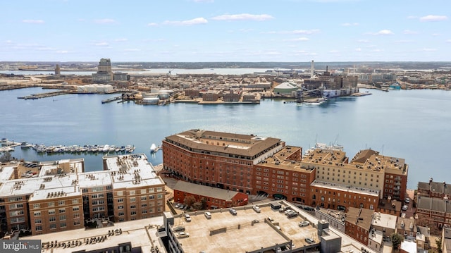 drone / aerial view featuring a view of city and a water view