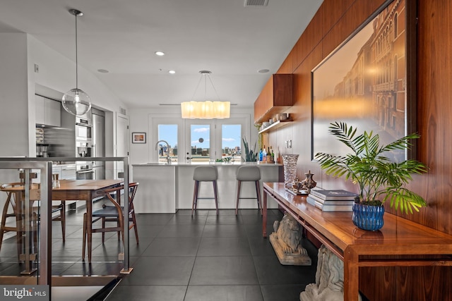 dining space with recessed lighting, visible vents, and dark tile patterned flooring