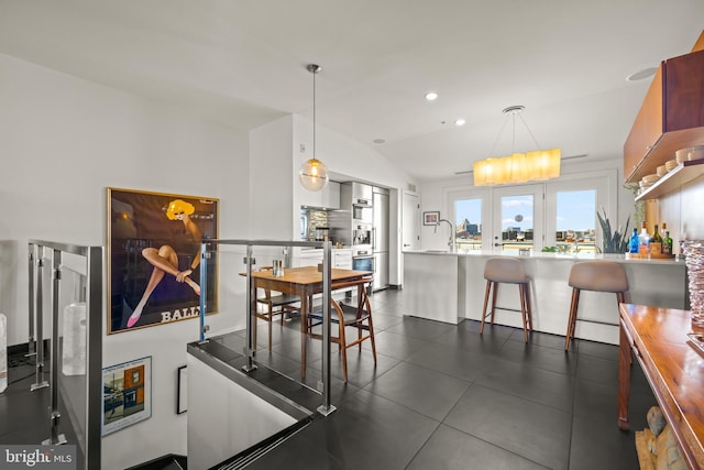 dining room with recessed lighting and vaulted ceiling