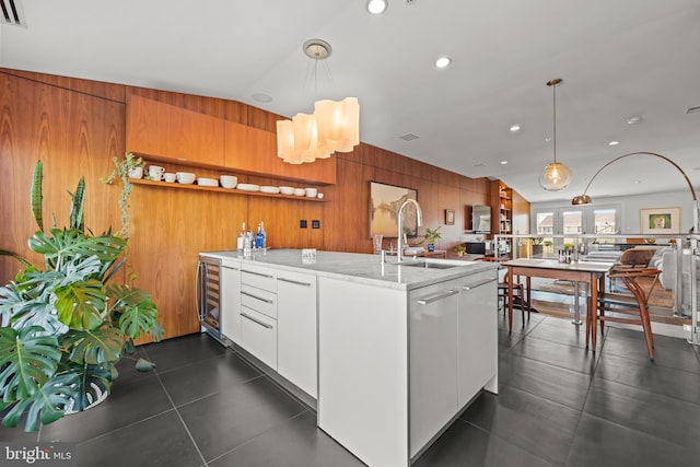 kitchen with a sink, beverage cooler, decorative light fixtures, modern cabinets, and open shelves