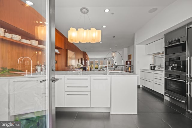 kitchen with white cabinets, modern cabinets, light countertops, and a sink