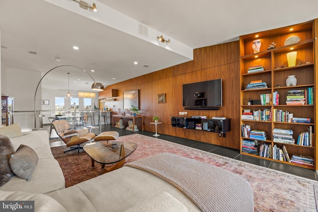 tiled living area featuring recessed lighting, visible vents, and wood walls