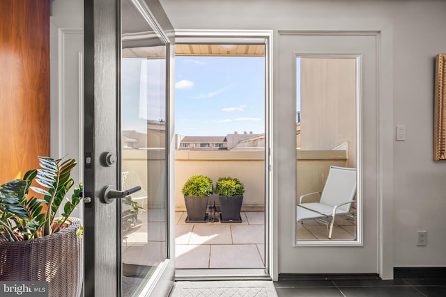 doorway to outside featuring tile patterned floors