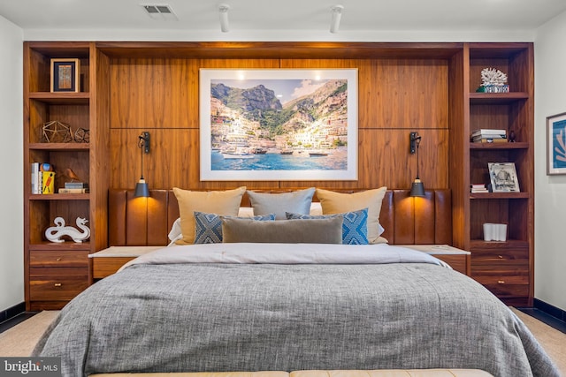 carpeted bedroom featuring visible vents and baseboards