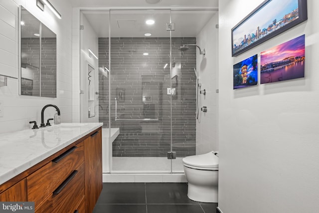 bathroom with tile patterned floors, a shower stall, toilet, and vanity