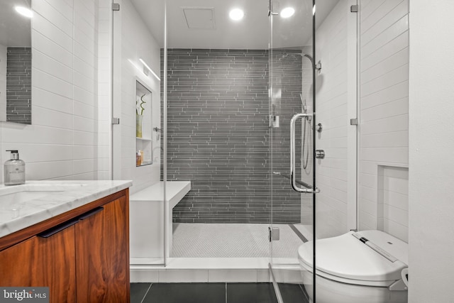 full bath featuring tile walls, toilet, and a stall shower