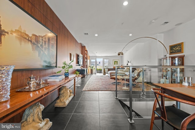 corridor featuring visible vents, recessed lighting, and dark tile patterned flooring