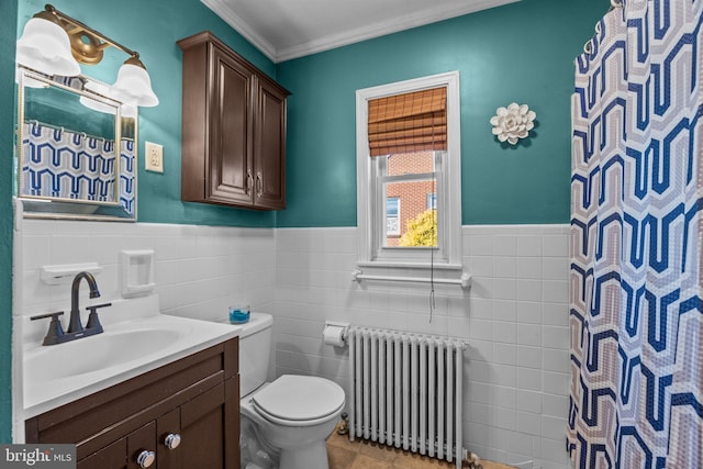 bathroom with vanity, toilet, tile walls, and radiator heating unit