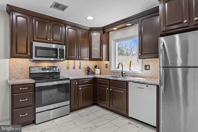 kitchen with visible vents, marble finish floor, a sink, stainless steel appliances, and dark brown cabinetry